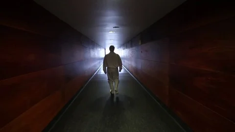 Worker walking through corridor in suit Stock Footage 77045072