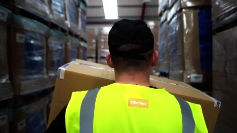 Worker Walking Through Warehouse Carrying Box Stock Footage 156499385
