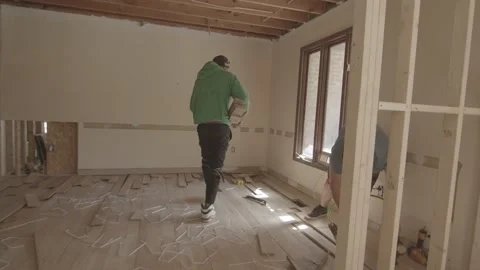 Worker walks through construction site Stockbeeldmateriaal 144294724