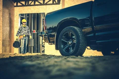 Worker Walks Towards Construction Site With Tools Foto stock