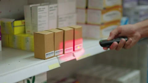Worker in warehouse is scanning the QR code next to the box inside the warehouse Stock Footage 172407037