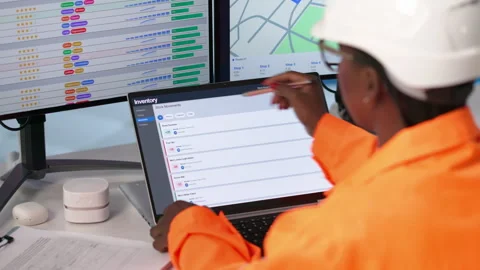 Worker In Warehouse Uses Computer To Manage Inventory Stock Footage 338174151