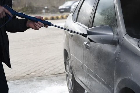 A worker  to wash the side mirrors Stock Photos