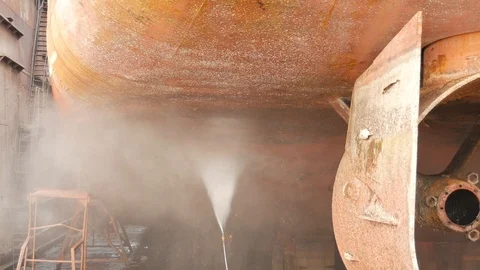 The worker washes the back of the ship's hull in the dock Stock Footage 87505454