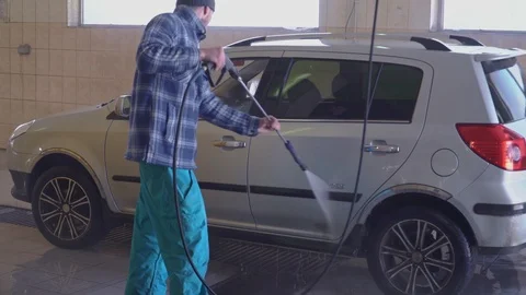 Worker washes a car with high pressure water Stock Footage 105966284