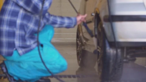 Worker washes a car with high pressure water close-up Stock Footage 105966376