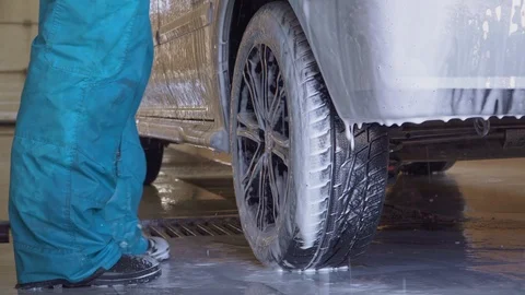 Worker washes a car with high pressure water and foam Stock Footage 105966559