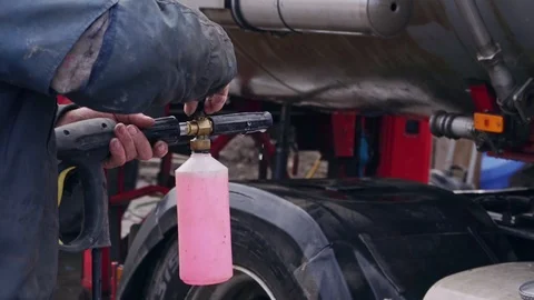 A worker washes with floam a large truck with a chester close-up Stock Footage 104147335