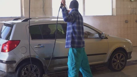 Worker washes gray car at the car wash Stock Footage 105966219