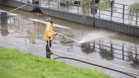 Worker washes mud and slit from the pavement. Stock Footage 141985158