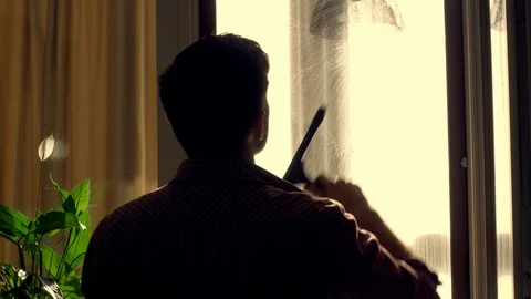 A worker washes a window at home, uses special tools Stock Footage 129991585