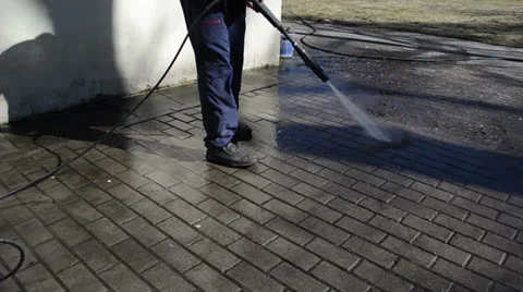 Worker washes yard tiles Stock Footage 25327230