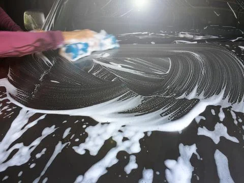 Worker washing car with sponge. Stock Photos