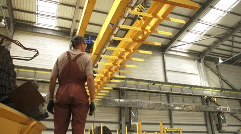 Worker watches as the moving crane is passing by Stock Footage 34829942