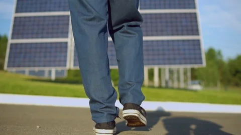 Worker wearing blue denim walking to the solarcell battery Stock Footage 93817850