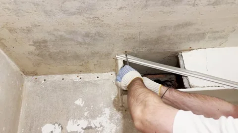 A worker wearing gloves while renovating a room Stock Footage 335140123
