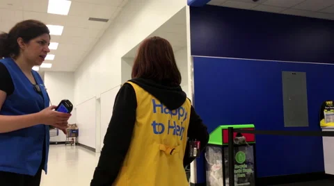 Worker wearing happy to help clothes in Walmart store Stock Footage 62360794