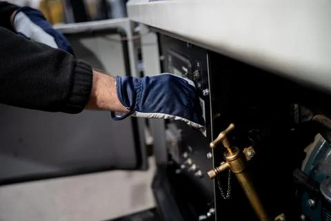 Worker wearing protective glove operating industrial control panel Stock Photos