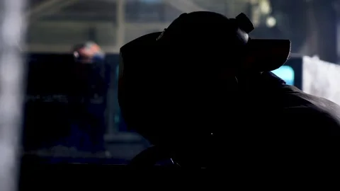 A worker wearing a protective mask welds metal in heavy manufacturing Stock Footage 244256835