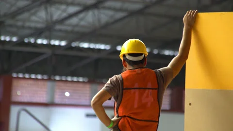A worker wearing security clothes rest a moment Stock Footage 132409354