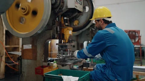 Worker wears hard hat, blue jumpsuit, and white gloves Stock Footage 341651674