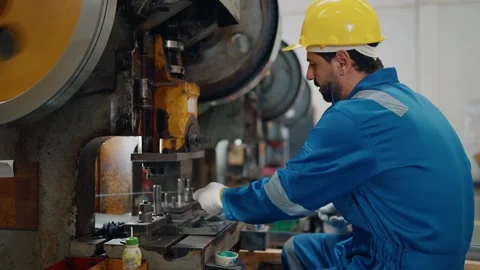 Worker wears hard hat, blue jumpsuit, and white gloves Stock Footage 341651688