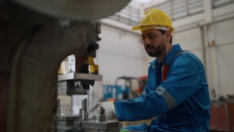 Worker wears hard hat, blue jumpsuit, and white gloves Stock Footage 341651735