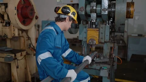 Worker wears hard hat, blue jumpsuit, and white gloves Stock Footage 341651736
