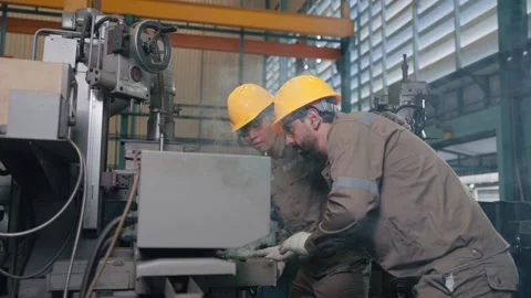 Worker wears hard hat, gloves, and work clothes Stock Footage 346269049