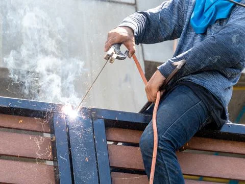 Worker is weding with out safety set Stock Photos