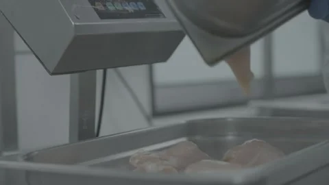 Worker weighing raw chicken breasts on industrial scale Stock-Footage 327353665
