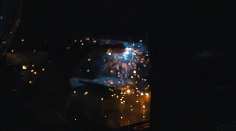 Worker weld of the metal structures in the dark. Sparks fly nicely on around Stock Footage 68355406