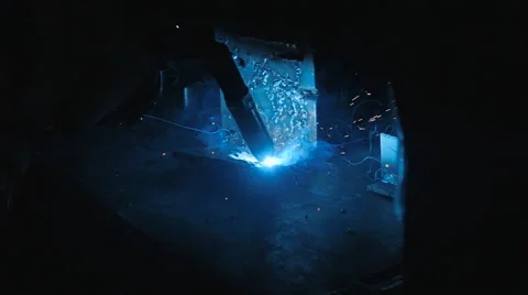 Worker weld of the metal structures in the dark. Sparks fly nicely on around Stock Footage 68355430