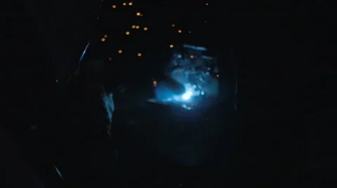 Worker weld of the metal structures in the dark. Sparks fly nicely on around Stock Footage 68355443