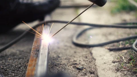 Worker welder performs welding work outside. Electric welding Stock Footage 128207660