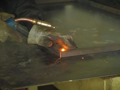 A Worker, welder in work clothes, construction gloves and a welding mask Stock Footage 255132174