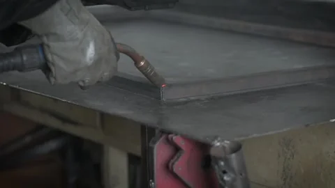 A Worker, welder in work clothes, construction gloves and a welding mask Stock Footage 255133977