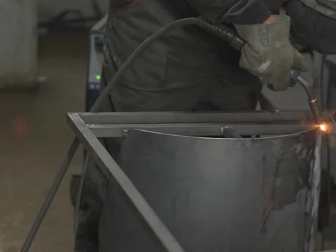 A Worker, welder in work clothes, construction gloves and a welding mask Stock Footage 255151253