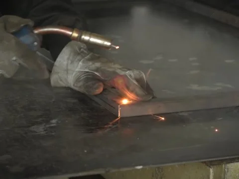 A Worker, welder in work clothes, construction gloves and a welding mask Stock Footage 255151276