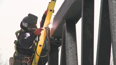 Worker welding bridge metal beam during Winter Stock Footage 63919990