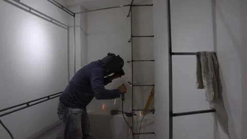 Worker welding a dressing room in a home renovation Stock Footage 150913525