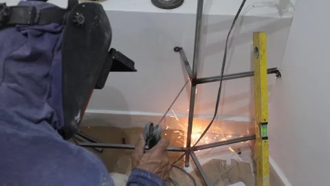 Worker welding a dressing room in a home renovation Stock Footage 150913549
