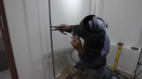 Worker welding a dressing room in a home renovation Stock Footage 150913613