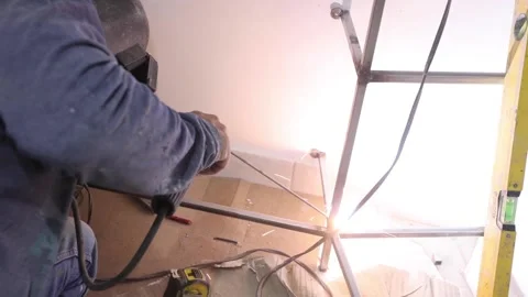 Worker welding a dressing room in a home renovation Stock Footage 150913758