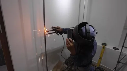 Worker welding a dressing room in a home renovation Stock Footage 150913808