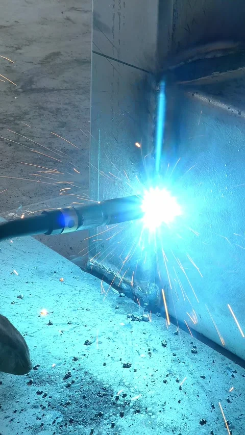 Worker welding in a factory at vertical composition video with sound Stock Footage 313016896