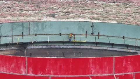 Worker Welding on Large Storage Tank Wall with PPE Stock Footage 309101777