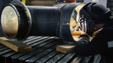 The worker with the welding mask inside the factory. The welding process of a Stock Footage 84825991