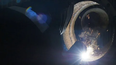 The worker with the welding mask inside the factory. The welding process of a Video stock 84830321