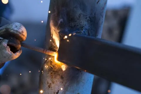 Worker welding metal elements on site, Stock Photos